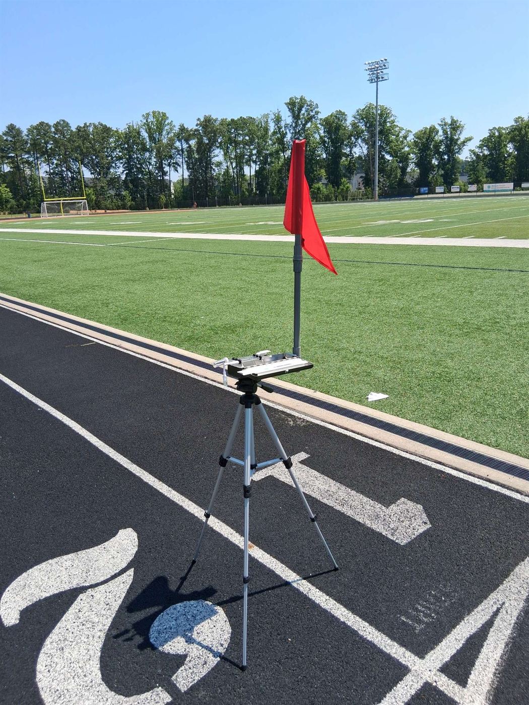Premium WBGT Kit on tripod with red heat-category flag monitoring conditions trackside